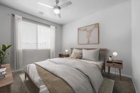 a bedroom with a large bed and a ceiling fan