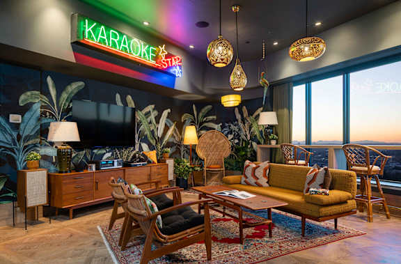 a lobby with couches and tables and a tree