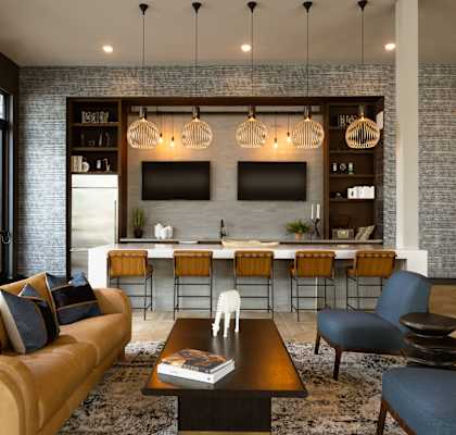 A living room with a tan couch and a black coffee table.