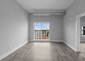 Thumbnail 2 of 10 - A room with a window overlooking a balcony.
