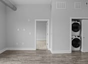Thumbnail 3 of 10 - A laundry room with a washer and dryer in it.