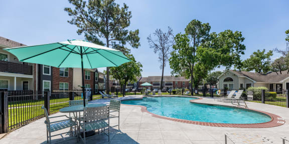our apartments offer a swimming pool with tables and umbrellas