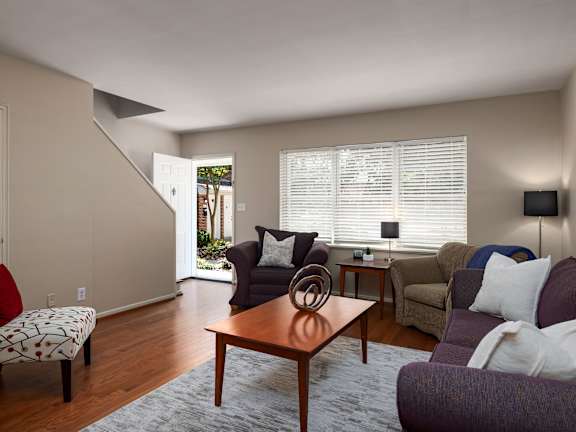 A living room with a couch, chair, and table.