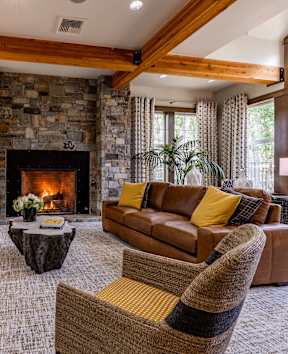 a living room with couches and chairs and a fireplace