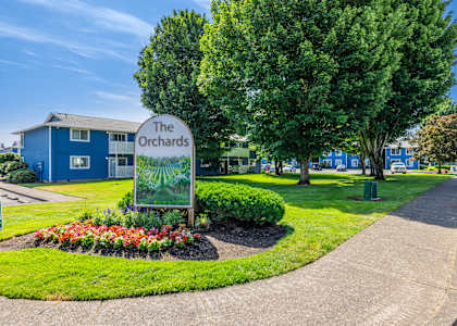 A blue building with a sign that says The Orchards.