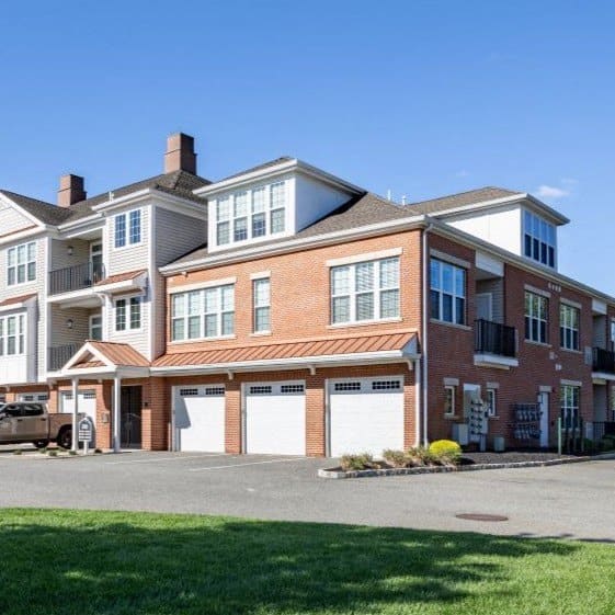 a large brick house with two garage doors