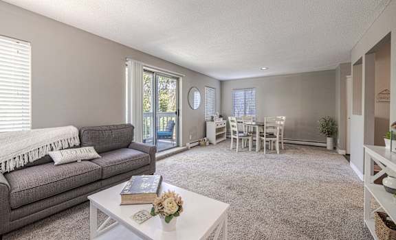 an open living room and dining room with a couch and a table