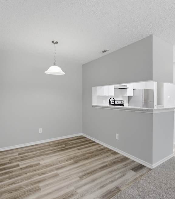 A room with a wooden floor and a white ceiling.
