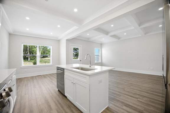 A modern kitchen with white cabinets and a large island.