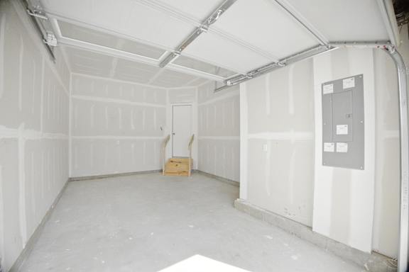 A room with white walls and a wooden box on the floor.