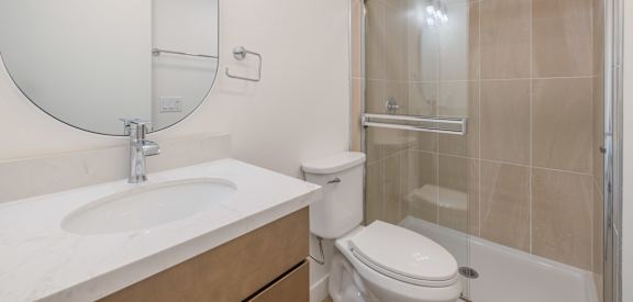 A bathroom with a sink, toilet, and shower.