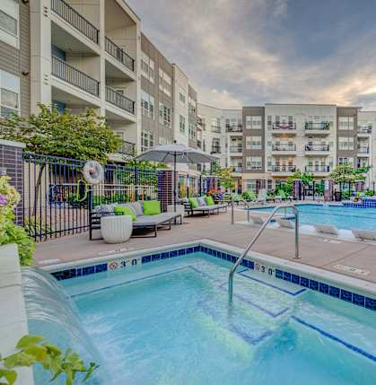 A swimming pool surrounded by apartment buildings.
