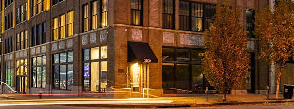 a large brick building with many windows at dusk