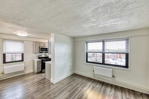 A room with a window and a desk.