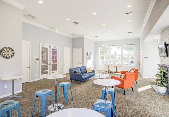 a living room with blue and orange furniture and stools at Valencia at Gale Ranch, San Ramon, CA, 94582