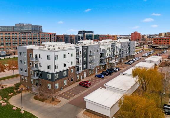 A view of a city with apartment buildings and cars.