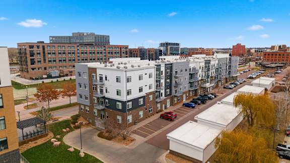 A view of a city with apartment buildings and cars.