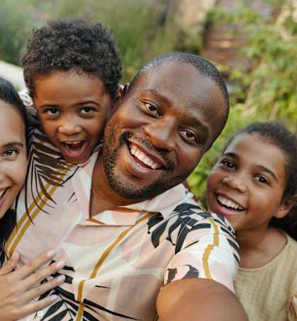 a family of four smiles for a picture