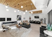 Thumbnail 24 of 32 - A modern living room with a wooden ceiling and a variety of furniture at Alante Homes at Spring Run, Caldwell, ID, 83607