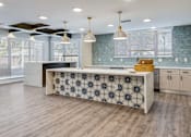 Thumbnail 6 of 7 - A kitchen with a patterned island in the middle.