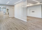 Thumbnail 4 of 7 - A room with a white column and wood flooring.
