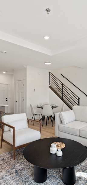 A living room with a television, couches, and a bar area.