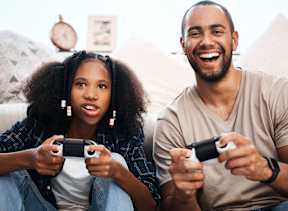 A man and a woman are playing video games together.