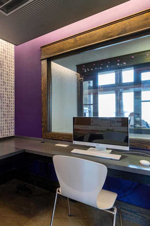 A reception area with a piano and chairs.