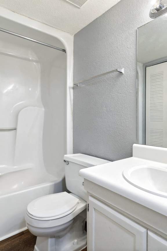 a bathroom with a sink toilet and a bath tub