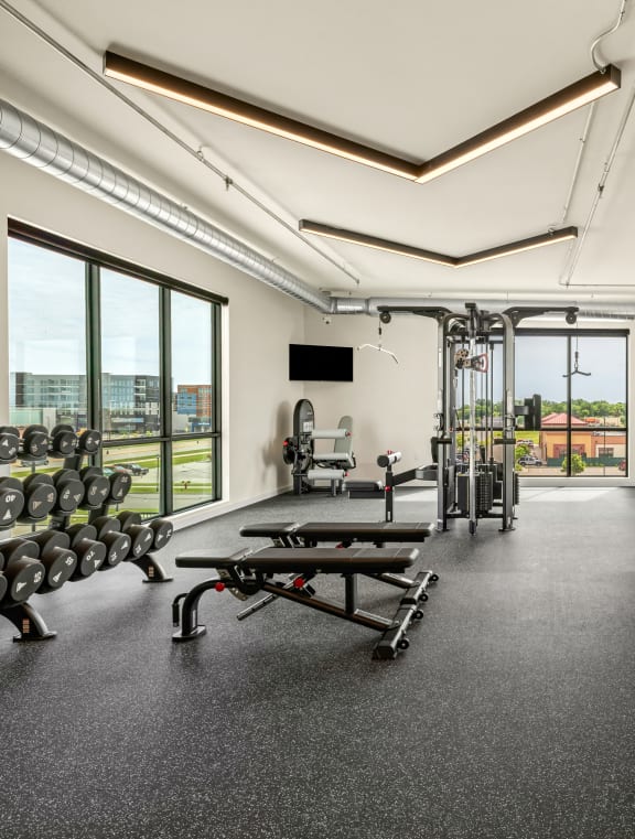 a gym with cardio machines and weights on the floor at The Standard on 32nd, North Dakota, 58078