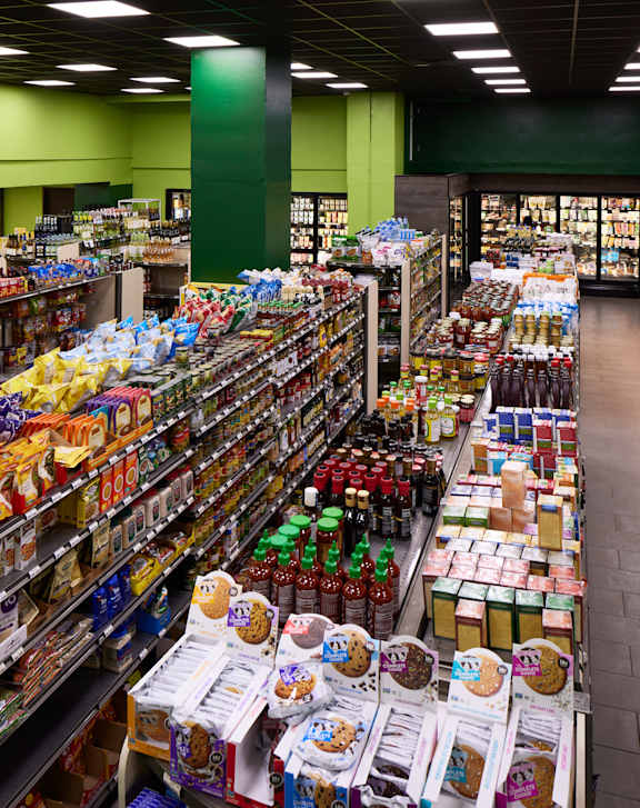 A supermarket aisle with a variety of snacks and drinks.
