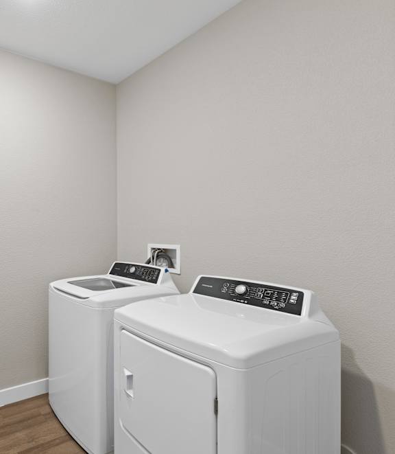 A small laundry room with a washer and dryer. at Agave House Apartments, Casa Grande, 85122