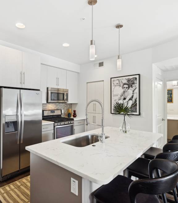 a kitchen with stainless steel appliances and white cabinets