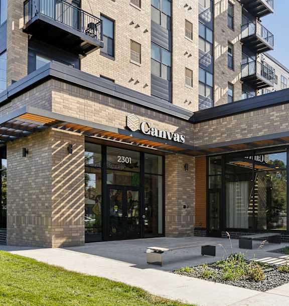 The Canvas building is a modern structure with a glass facade and a wooden exterior.