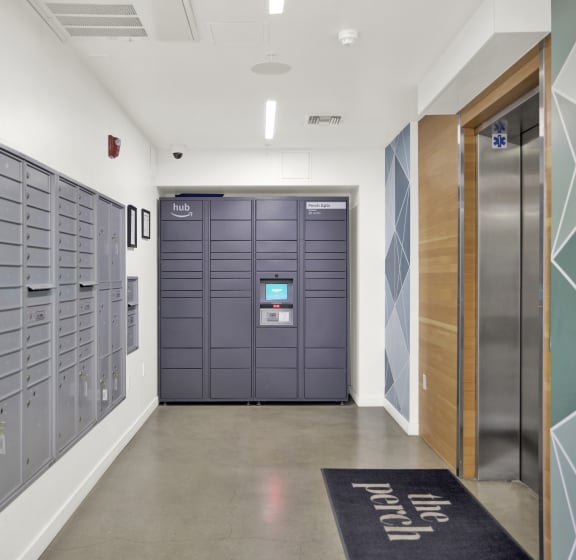 a long hallway with lockers and a door to a locker room with a rug at the perch, Los Angeles, California