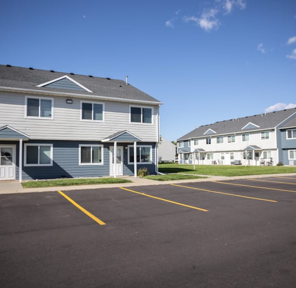 a parking lot in front of a row of houses