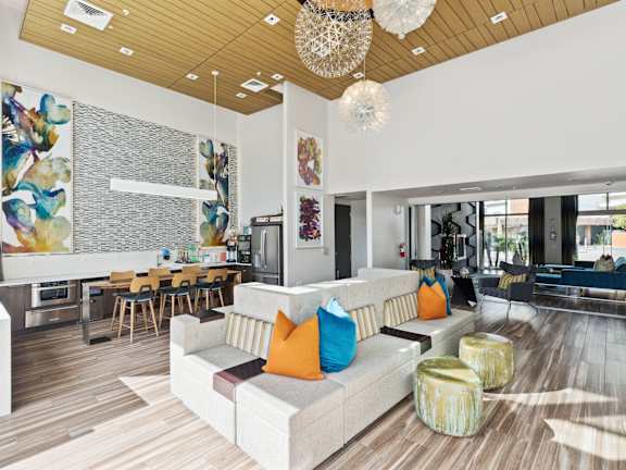 a lobby with a blue couch and wood floors