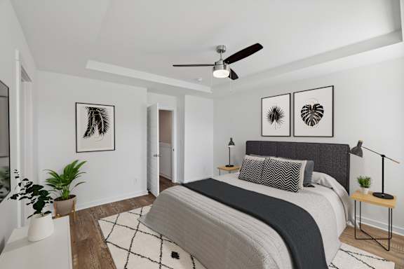 A living room with a white couch, a coffee table, and a ceiling fan.