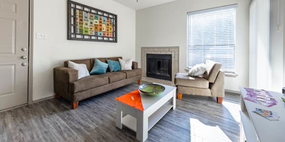 a living room with couches and a coffee table and a fireplace
