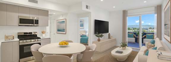 a living room with white walls and a green couch
