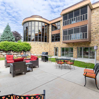 A patio area with a table and chairs outside a building.