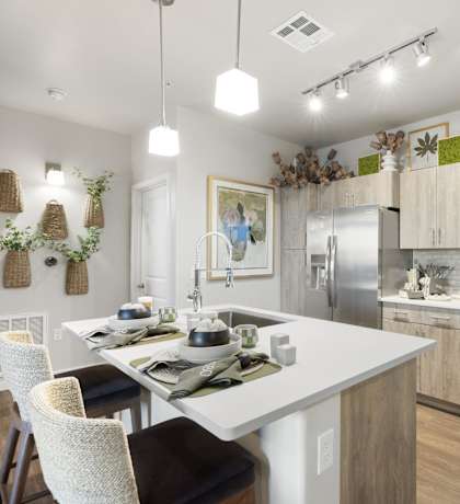 A modern kitchen with a dining table and chairs.