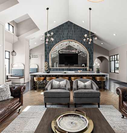 A modern living room with a fireplace and leather couches.