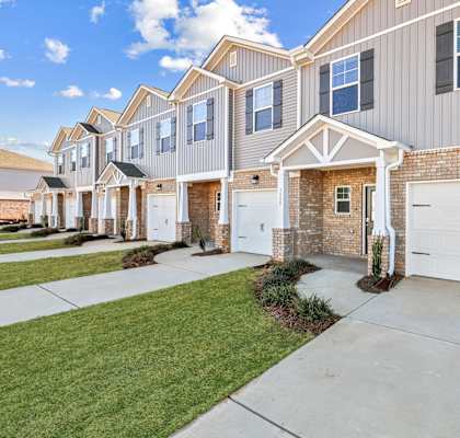 A row of houses with garages in front.