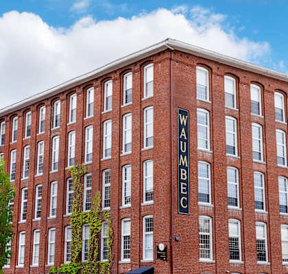 A red brick building with the word WUMBEC on the side.