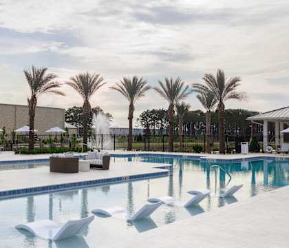 A large swimming pool with a white sculpture in the middle.