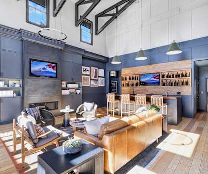 A modern living room with a wooden floor and a large sectional sofa.