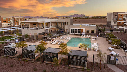 A resort with a pool and a sunset.