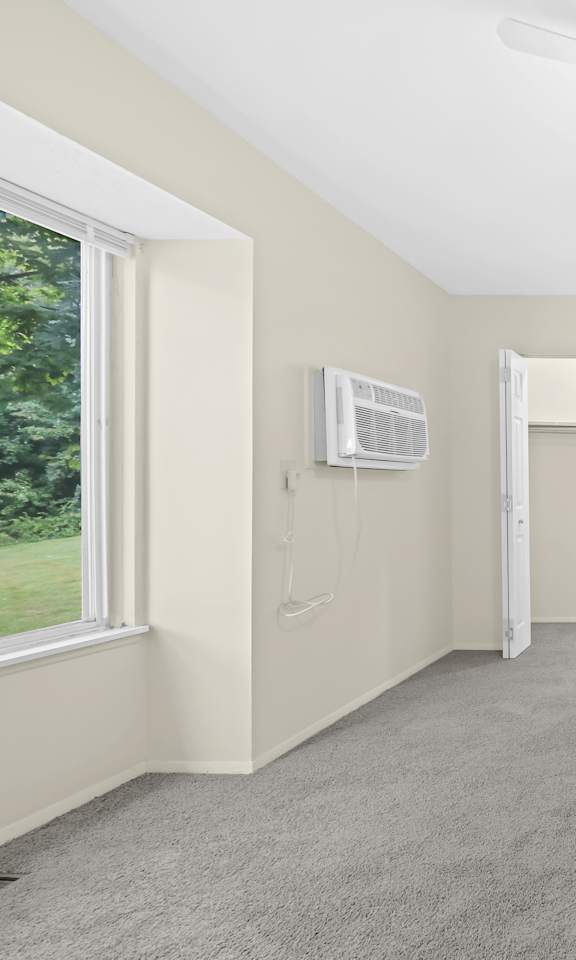 Empty room with a ceiling fan and three doorways.