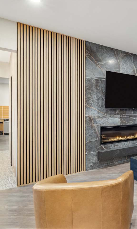a living room with a couch and a chair and a fireplace